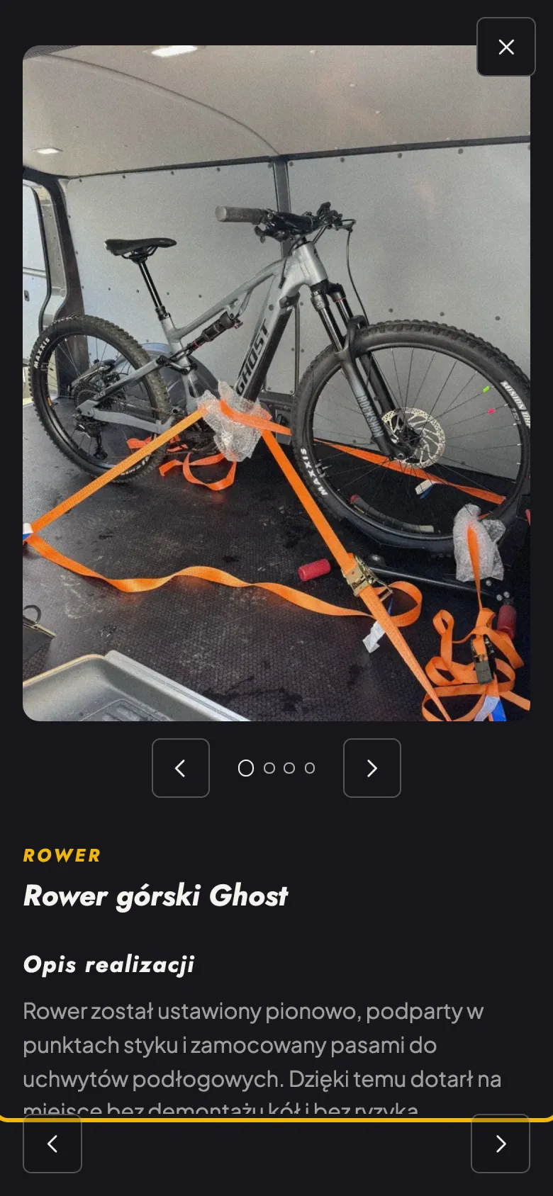 Panel realizacji „Rower górski Ghost” na telefonie: zdjęcie całego roweru przypiętego pomarańczowymi pasami w busie, pod nim strzałki galerii i opis realizacji.