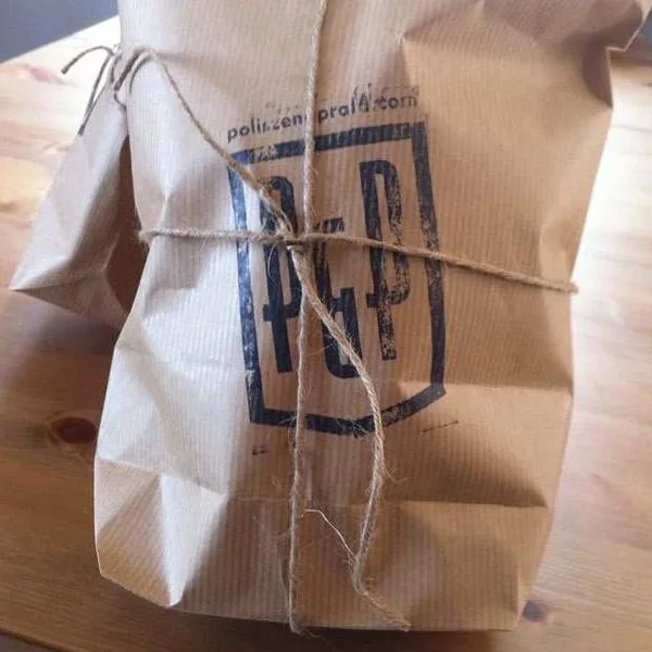 Kraft-paper package tied with twine and hand-stamped with the Polisze logo.
