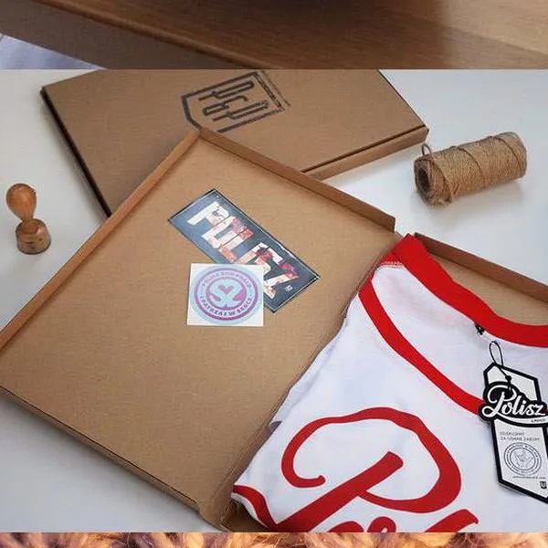 Kraft box packed with a red printed jersey, hang tag and stickers.