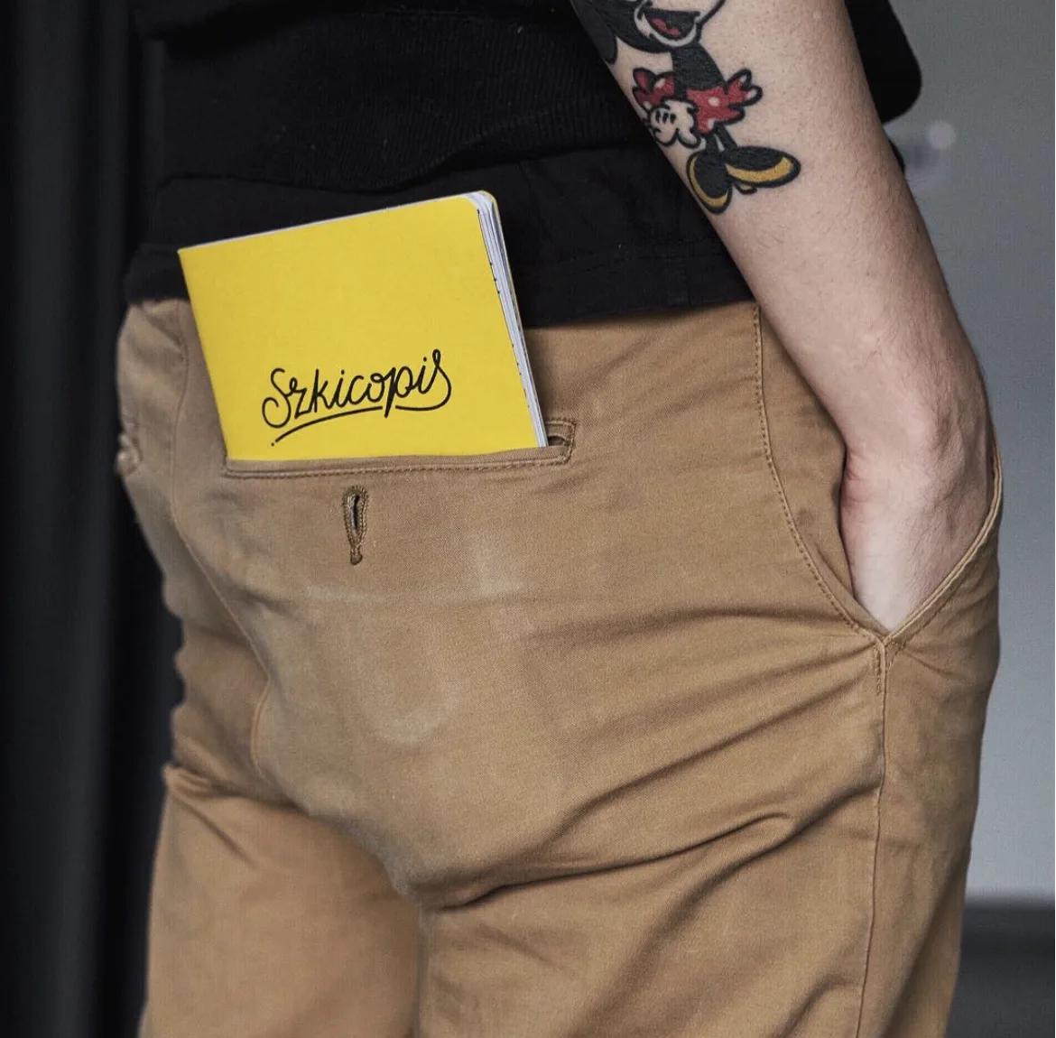 A yellow Szkicopis notebook tucked into a back pocket.